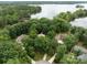 A beautiful aerial view captures a lake home surrounded by lush greenery and serene water at 165 Futrell Lndg, New London, NC 28127