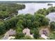 Aerial view of a charming home nestled in a serene, wooded neighborhood near a beautiful lake at 165 Futrell Lndg, New London, NC 28127