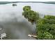 Aerial shot of a lake community with lush islands and docks, showcasing stunning waterfront property at 165 Futrell Lndg, New London, NC 28127
