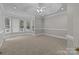 Spacious bedroom featuring a bay window area, neutral carpet, and tray ceiling with fan at 165 Futrell Lndg, New London, NC 28127