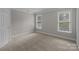 Bedroom with neutral carpet and natural lighting from two windows at 165 Futrell Lndg, New London, NC 28127