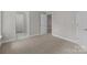 Neutral bedroom with carpet and doorways to bathroom and closets at 165 Futrell Lndg, New London, NC 28127
