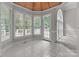Bright breakfast nook with a unique ceiling and floor-to-ceiling windows overlooking the backyard at 165 Futrell Lndg, New London, NC 28127