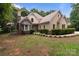 Charming stucco home featuring a stone facade, manicured landscaping, and inviting curb appeal at 165 Futrell Lndg, New London, NC 28127
