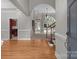 Bright foyer with hardwood floors, arched doorway, and staircase leading to the upper level at 165 Futrell Lndg, New London, NC 28127