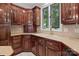 Corner of the kitchen highlighting cabinetry, built-in wine rack, and bright double-basin sink at 165 Futrell Lndg, New London, NC 28127