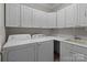Well-equipped laundry room with a washer, dryer, and ample storage cabinets at 165 Futrell Lndg, New London, NC 28127