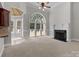 Spacious living room with fireplace, large windows, and access to the backyard deck at 165 Futrell Lndg, New London, NC 28127