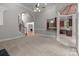 View of the carpeted living room with open staircase and a glimpse into the gourmet kitchen at 165 Futrell Lndg, New London, NC 28127