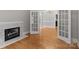 Living room features hardwood floors, fireplace, and French doors leading to dining room at 165 Futrell Lndg, New London, NC 28127