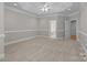 Large primary bedroom with neutral carpet, tray ceiling, and ensuite bathroom access at 165 Futrell Lndg, New London, NC 28127