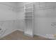 Organized walk-in closet with shelving and hanging rods, offering ample storage space at 165 Futrell Lndg, New London, NC 28127