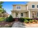 Inviting two-story home with yellow siding, a covered porch, and manicured landscaping creating great curb appeal at 1670 Robins Nest Ct # D, Gastonia, NC 28054