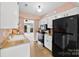 Cozy kitchen features stainless appliances, white cabinetry, wood counters, and an eat-in area at 1670 Robins Nest Ct # D, Gastonia, NC 28054