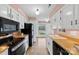 Cozy kitchen features stainless appliances, white cabinetry, wood counters, and an eat-in area at 1670 Robins Nest Ct # D, Gastonia, NC 28054