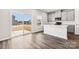 Bright kitchen with white cabinets, stainless steel appliances, and sliding glass doors to the backyard at 2125 Rolling Hills Ct, Stanley, NC 28164