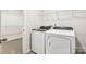 Laundry room with white washer and dryer, wire shelving, and neutral paint at 2125 Rolling Hills Ct, Stanley, NC 28164