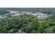 Aerial view of a neighborhood surrounded by lush greenery and nearby commercial areas at 2332 Hemby Pl, Charlotte, NC 28270