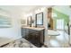 A bathroom features a double sink vanity, stone flooring, and a view into the main bedroom at 2332 Hemby Pl, Charlotte, NC 28270
