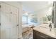 A bathroom showcases a soaking tub with tiled surround and a vanity with marble countertops at 2332 Hemby Pl, Charlotte, NC 28270