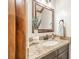 Powder room featuring granite countertop, decorative mirror, and stylish sink at 2332 Hemby Pl, Charlotte, NC 28270