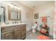 Cozy bathroom featuring a wood-framed mirror, vanity, and linen closet at 2332 Hemby Pl, Charlotte, NC 28270