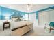 Bright bedroom with blue walls, featuring a bed, ceiling fan, and double door closets at 2332 Hemby Pl, Charlotte, NC 28270