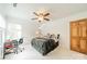 A bedroom features a ceiling fan, a gray bedspread, and a small desk next to the window at 2332 Hemby Pl, Charlotte, NC 28270