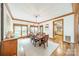 Sunlit dining area with wood floors, modern light fixture, and adjacent kitchen area at 2332 Hemby Pl, Charlotte, NC 28270
