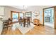 Dining area with wood floors, a modern light fixture, sliding glass door, and a cabinet at 2332 Hemby Pl, Charlotte, NC 28270