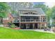 Charming brick home featuring a covered deck with outdoor seating and a beautifully landscaped backyard at 2332 Hemby Pl, Charlotte, NC 28270