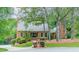 Charming brick home featuring a manicured lawn and lush landscaping at 2332 Hemby Pl, Charlotte, NC 28270