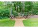 Backyard fire pit with chairs, perfect for outdoor gatherings in a lush, private setting at 2332 Hemby Pl, Charlotte, NC 28270