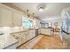 Spacious kitchen with white cabinets, granite countertops, stainless steel appliances, and wood floors at 2332 Hemby Pl, Charlotte, NC 28270