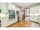Bright kitchen with stainless steel appliances, white cabinets, and wood flooring at 2332 Hemby Pl, Charlotte, NC 28270