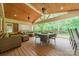 Inviting covered porch with wooden floors, comfortable seating, and serene outdoor views at 2332 Hemby Pl, Charlotte, NC 28270