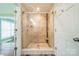 A tile-lined walk-in shower is enclosed in glass and features dual shower heads and a small bench at 2332 Hemby Pl, Charlotte, NC 28270