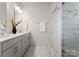 Double vanity bathroom features stone countertops and a walk-in shower with stone surround at 2600 Mason Cir # A, Charlotte, NC 28205