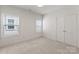 Bright bedroom with two windows and neutral carpet and paint at 2600 Mason Cir # A, Charlotte, NC 28205