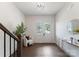 Sunlit foyer features hardwood flooring, a chair, and a decorative mirror at 2600 Mason Cir # A, Charlotte, NC 28205