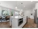 Bright, open kitchen boasts island with stainless appliances and view to living and dining spaces at 2600 Mason Cir # A, Charlotte, NC 28205