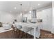 Bright kitchen featuring white cabinets, an island with bar stool seating, and stainless steel appliances at 2600 Mason Cir # A, Charlotte, NC 28205