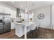 Modern kitchen featuring an island with bar stool seating, quartz counters, and stainless steel appliances at 2600 Mason Cir # A, Charlotte, NC 28205