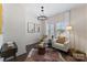 Cozy living room with neutral tones, two armchairs, side table, and natural light from the windows at 2600 Mason Cir # A, Charlotte, NC 28205