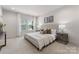 Beautifully staged main bedroom with a large window and neutral furnishings at 2600 Mason Cir # A, Charlotte, NC 28205