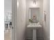 Charming powder room features a pedestal sink, stylish mirror, and is conveniently located off the kitchen at 2600 Mason Cir # A, Charlotte, NC 28205