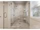 Modern bathroom shower with marble tiling, glass door, and sleek fixtures at 2600 Mason Cir # A, Charlotte, NC 28205