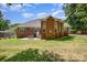 Exterior shot of a brick home's backyard, showcasing the patio and lawn at 2804 Pulaski Dr, Monroe, NC 28110
