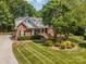 Charming brick home boasts lush landscaping, mature trees, and a well-manicured lawn for curb appeal at 2804 Pulaski Dr, Monroe, NC 28110