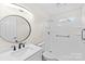 Bathroom featuring a round mirror, white vanity with black hardware, and a walk-in shower at 306 2Nd Avenue Ne Pl, Conover, NC 28613